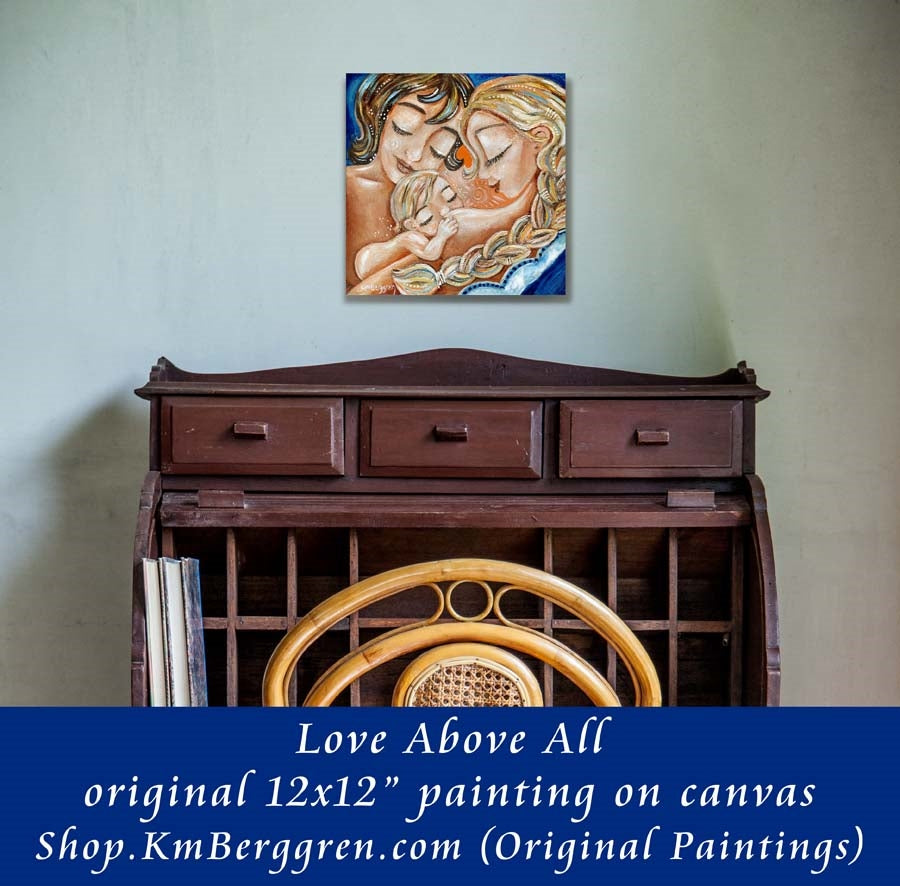 on wall view of original painting of two mothers with nursing baby, blonde braid, short brown hair, artwork by KmBerggren