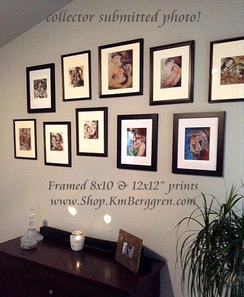 a collection of framed artwork by KmBerggren on a collectors wall