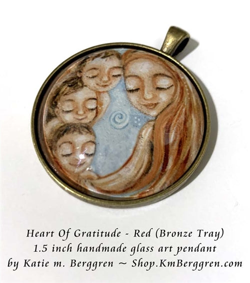 bronze glass art pendant of red haired mother with three children handmade by Katie m. Berggren