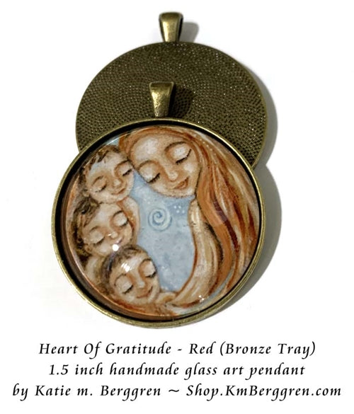 bronze glass art pendant of red haired mother with three children handmade by Katie m. Berggren