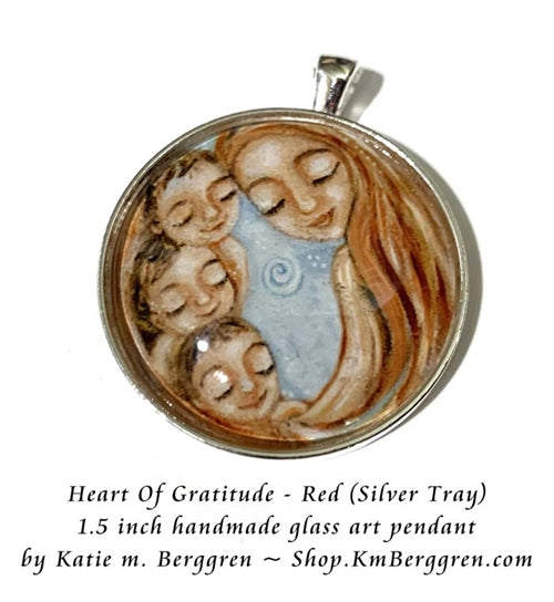 silver glass art pendant of red haired mother with three children handmade by Katie m. Berggren